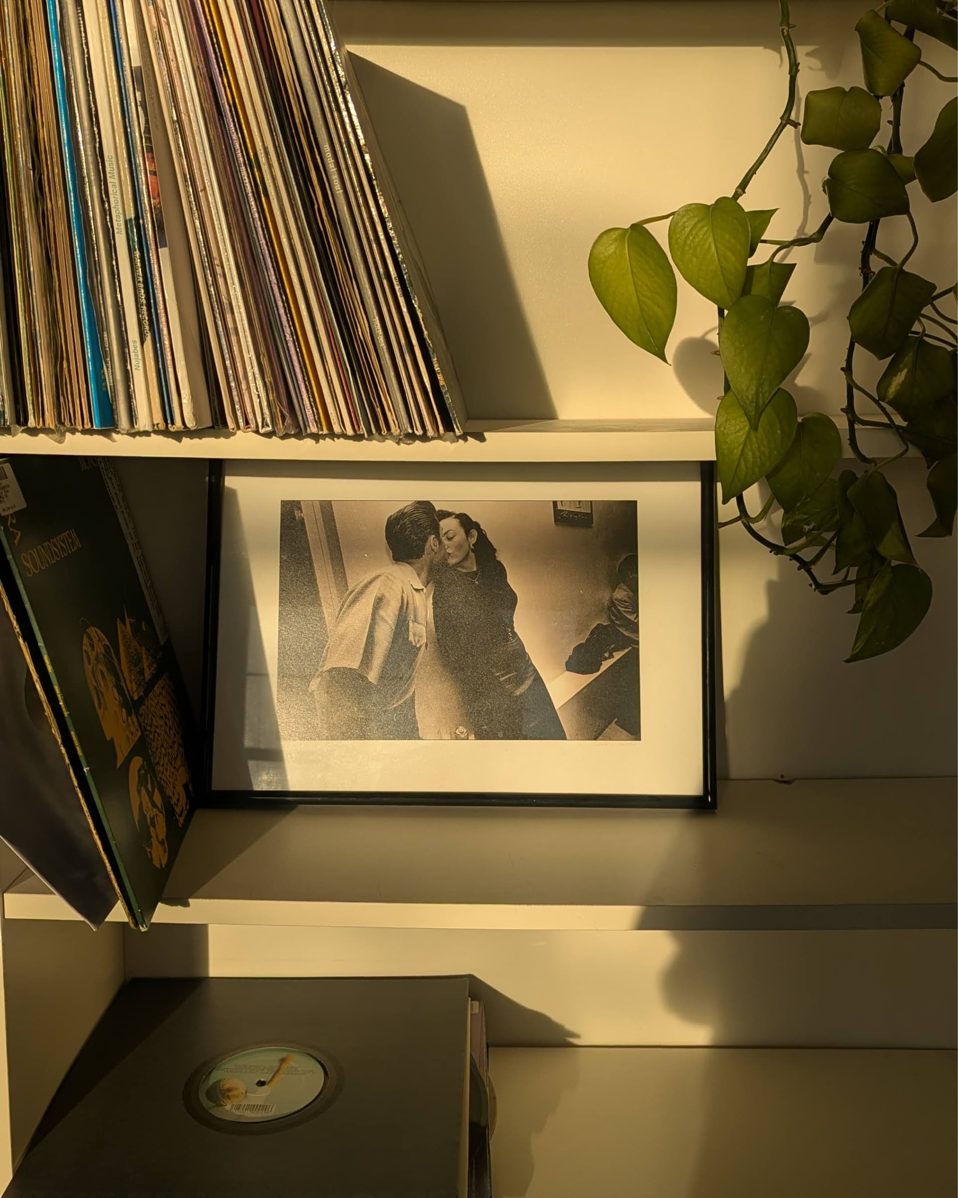 Bookshelf with vinyl records and framed print