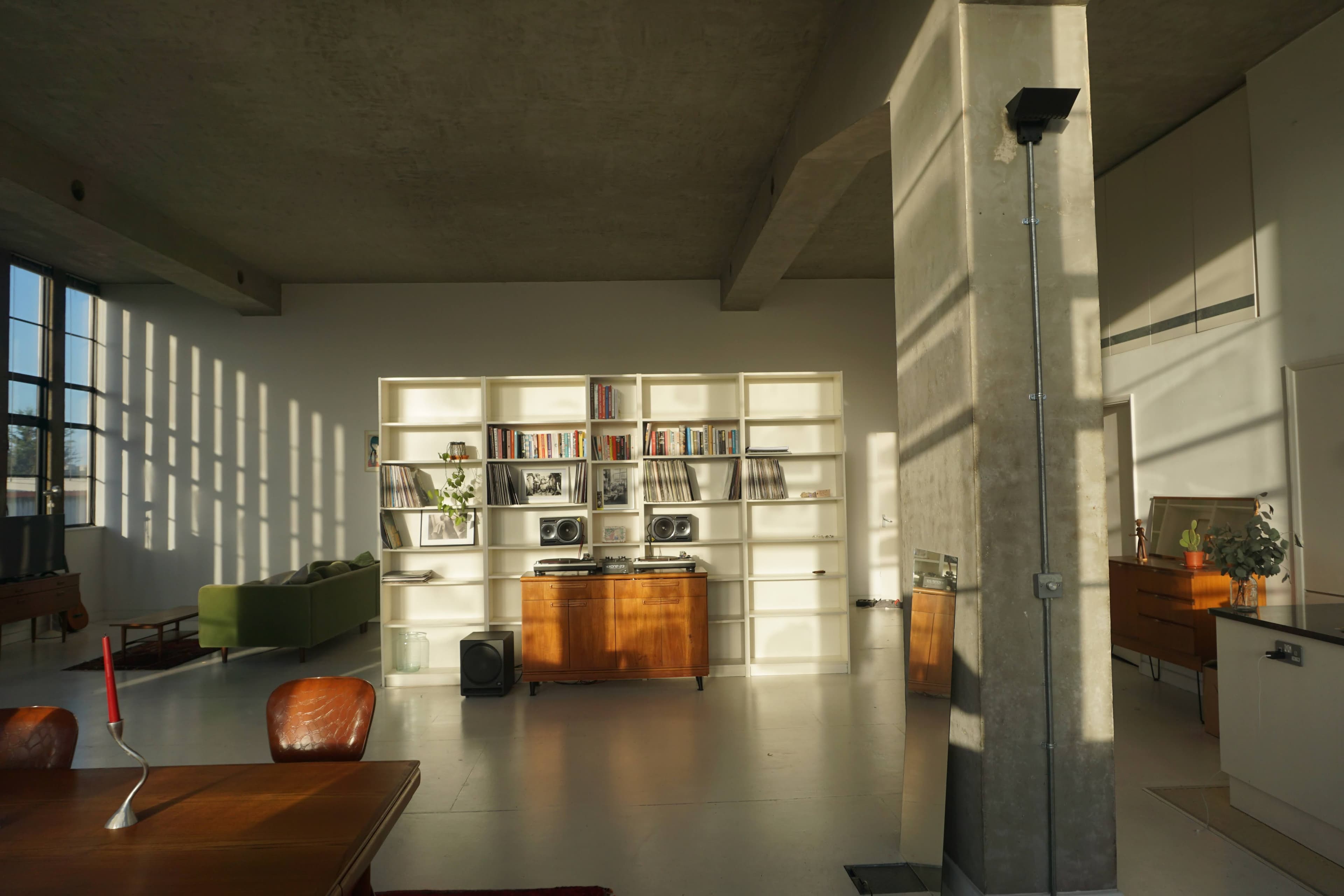 Studio Conch interior — natural light flooding through steel-framed windows