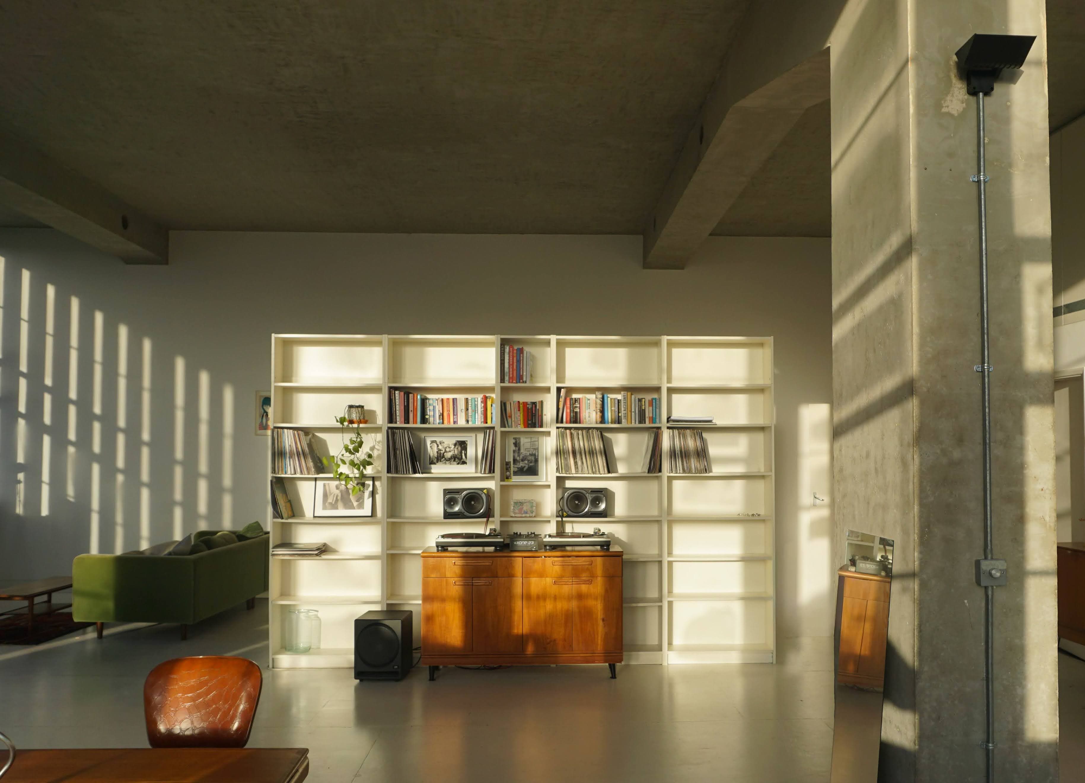Studio Conch interior — natural light flooding through steel-framed windows